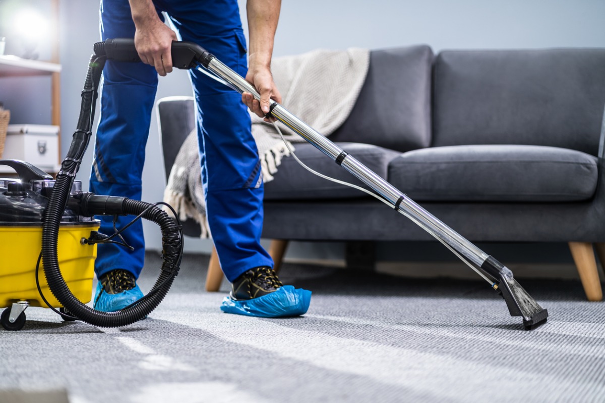 person-cleaning-carpet-with-vacuum-cleaner-picture